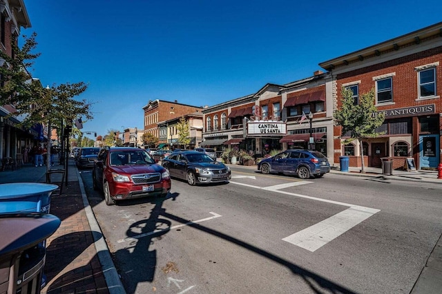 view of street featuring sidewalks, street lighting, and curbs