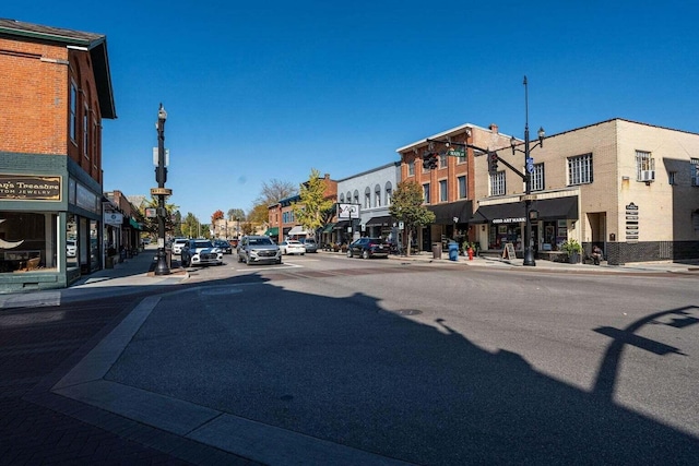 view of street with curbs, street lighting, and sidewalks