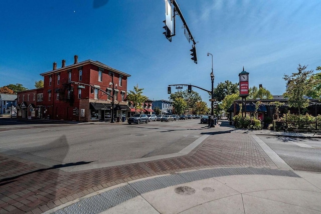 view of road featuring street lights, curbs, and sidewalks