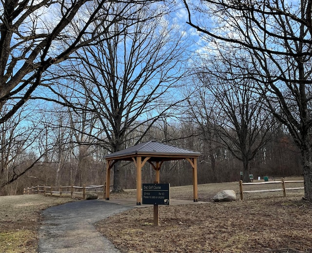 surrounding community with a carport, a gazebo, and aphalt driveway