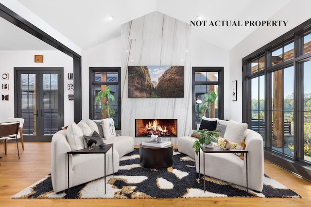 2835 Katmai Dr, Columbus, OH 43228 - living room featuring high vaulted ceiling, wood finished floors, french doors, and a fireplace
