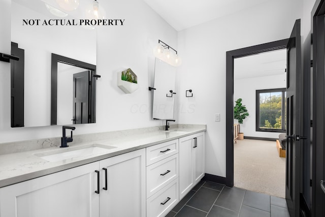 2835 Katmai Dr, Columbus, OH 43228 - full bath with baseboards, tile patterned flooring, double vanity, and a sink