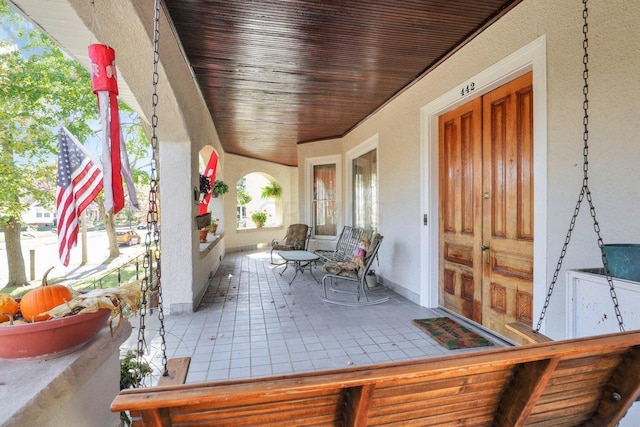 unfurnished sunroom with wooden ceiling and a healthy amount of sunlight