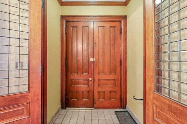 doorway to outside featuring light tile patterned floors and ornamental molding