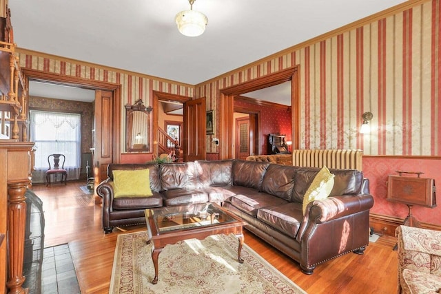 living room with radiator, ornamental molding, and hardwood / wood-style flooring