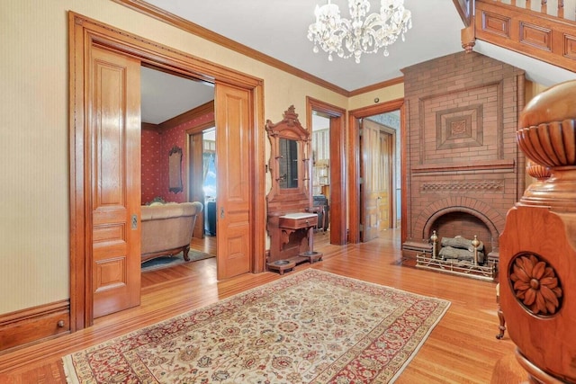 hallway featuring a notable chandelier, light wood-type flooring, and crown molding