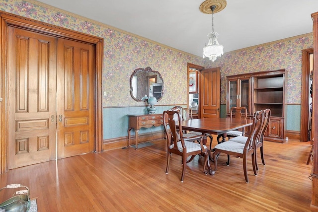 dining area featuring a notable chandelier and light hardwood / wood-style floors