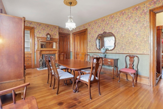 dining area featuring light hardwood / wood-style floors and a notable chandelier