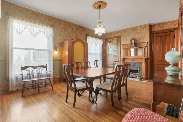 dining area featuring hardwood / wood-style floors and an inviting chandelier