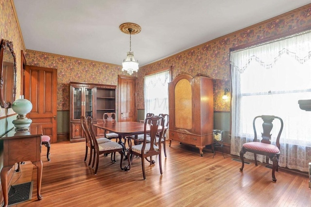 dining area with an inviting chandelier and hardwood / wood-style flooring