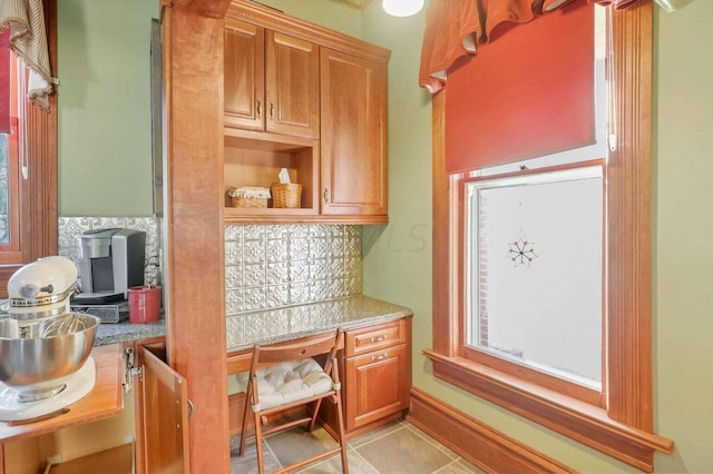 kitchen with light tile patterned flooring and tasteful backsplash