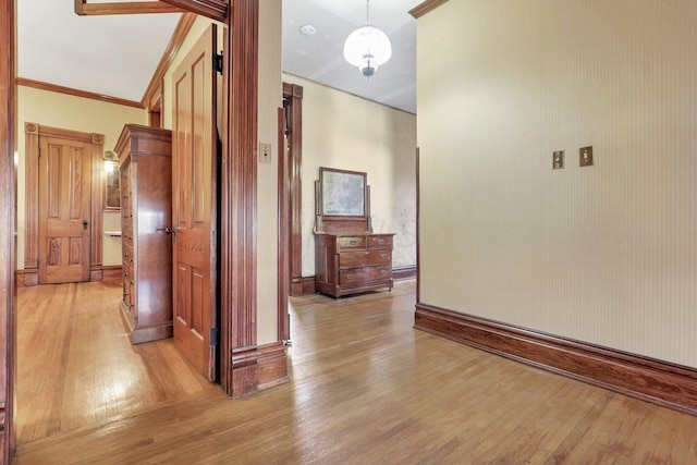 hall featuring ornamental molding and light wood-type flooring