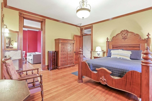 bedroom featuring ornamental molding and hardwood / wood-style flooring