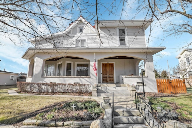 view of front of property with a porch and a front lawn