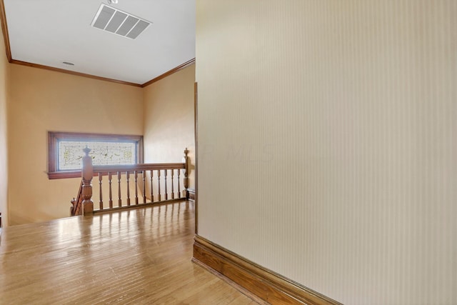 corridor featuring hardwood / wood-style floors and ornamental molding