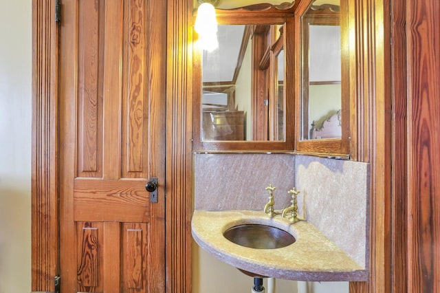 bathroom featuring backsplash and sink