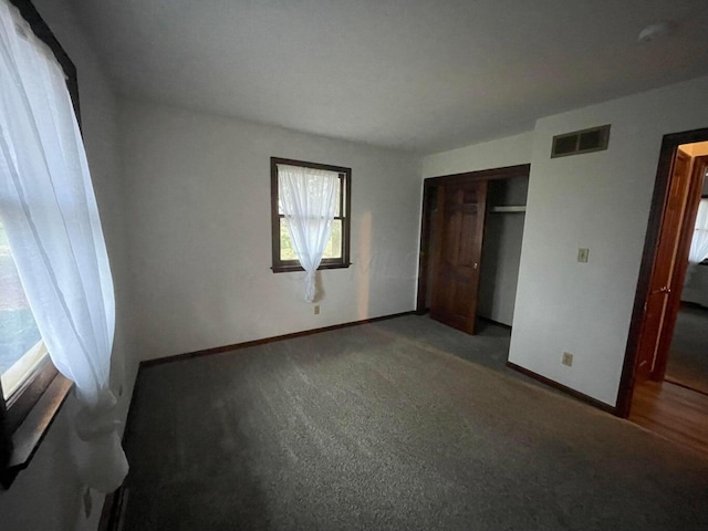 unfurnished bedroom with a closet and carpet