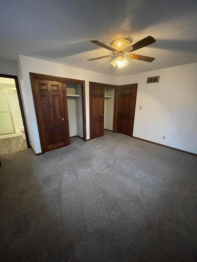 unfurnished bedroom featuring multiple closets, ceiling fan, and carpet floors