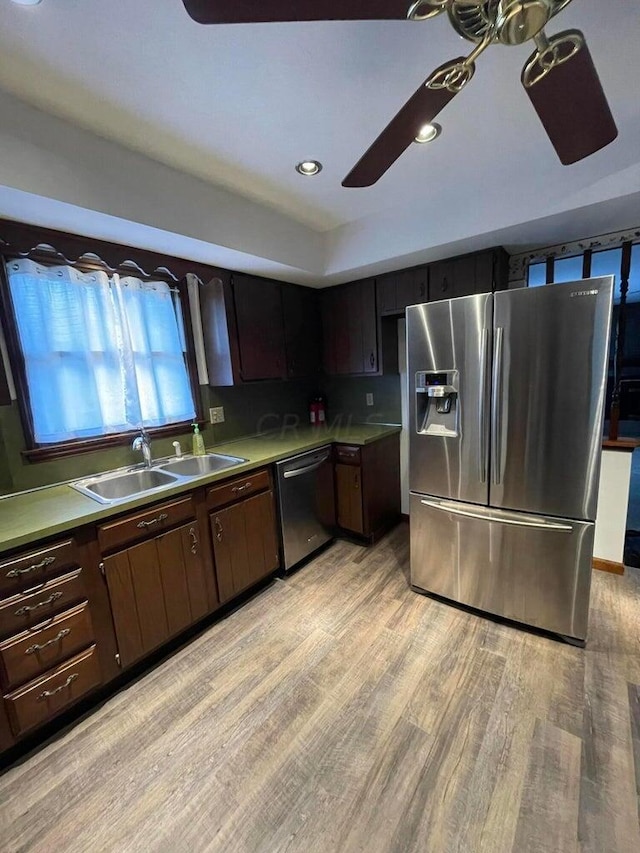 kitchen featuring sink, light hardwood / wood-style flooring, ceiling fan, dark brown cabinetry, and stainless steel appliances