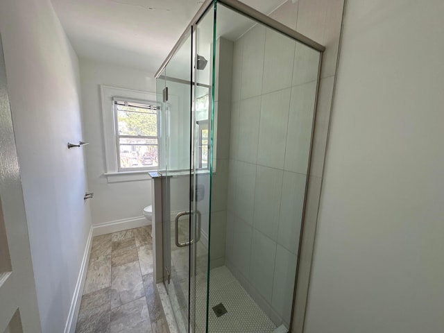 bathroom featuring toilet and walk in shower