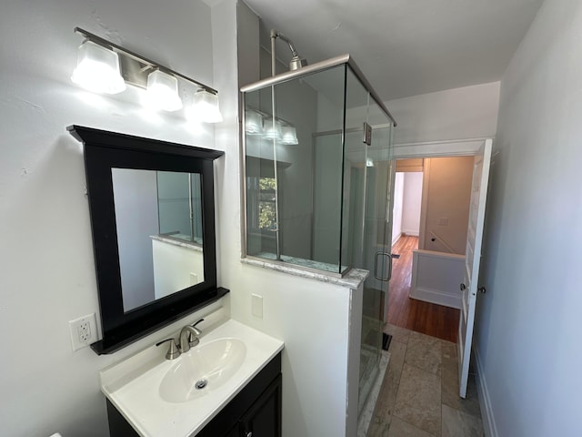 bathroom featuring vanity, a shower with shower door, and hardwood / wood-style flooring