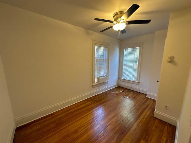 empty room with cooling unit, ceiling fan, and dark wood-type flooring