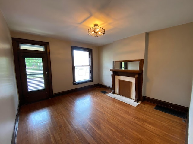 unfurnished living room featuring hardwood / wood-style flooring