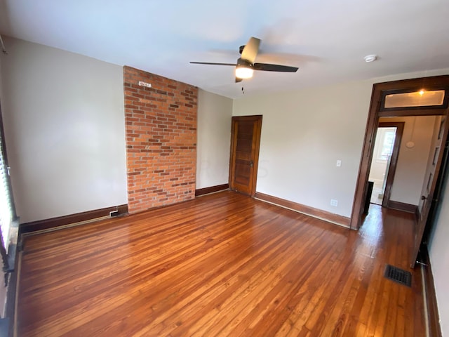 unfurnished room featuring ceiling fan and dark wood-type flooring