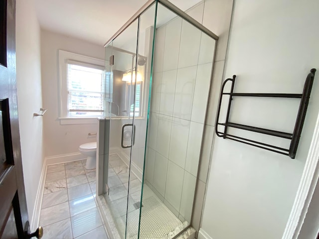 bathroom featuring tile patterned floors, a shower with shower door, and toilet