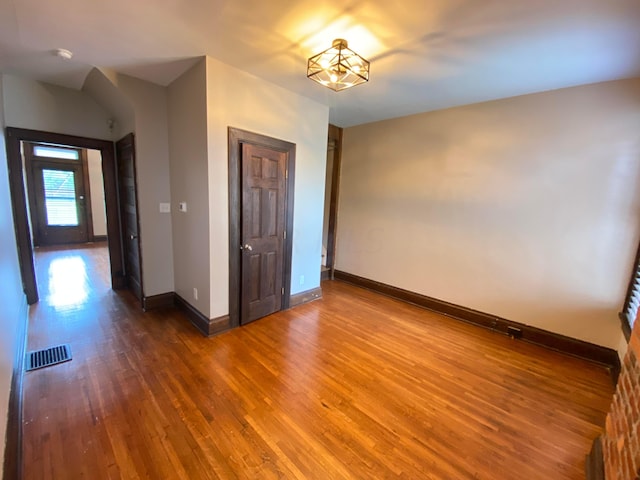 unfurnished room featuring hardwood / wood-style flooring