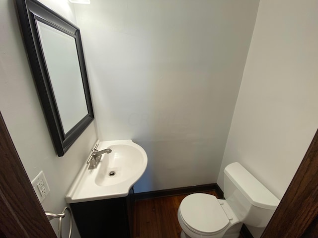 bathroom featuring hardwood / wood-style floors, vanity, and toilet