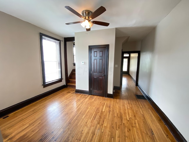 unfurnished bedroom with hardwood / wood-style floors and ceiling fan