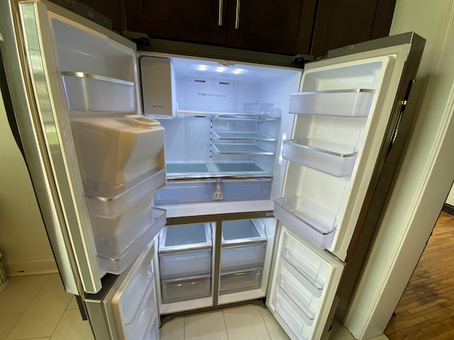 room details featuring white refrigerator and dark brown cabinetry