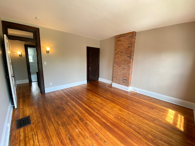 empty room featuring dark wood-type flooring