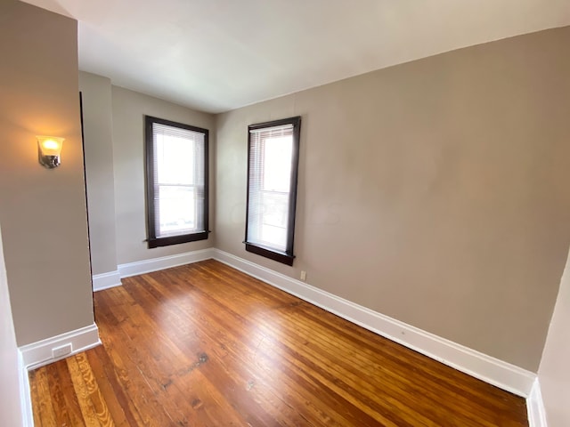 spare room featuring dark wood-type flooring