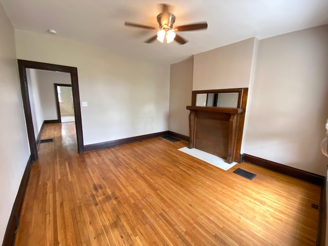 spare room with ceiling fan and hardwood / wood-style flooring