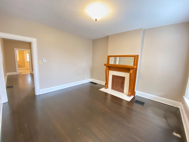 unfurnished living room featuring dark wood-type flooring