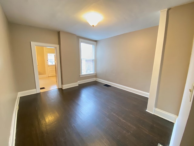 unfurnished room with dark hardwood / wood-style floors