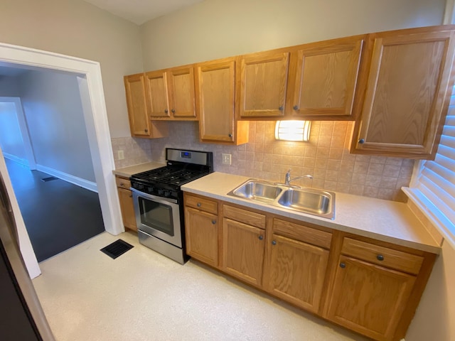 kitchen with backsplash, sink, and stainless steel gas range