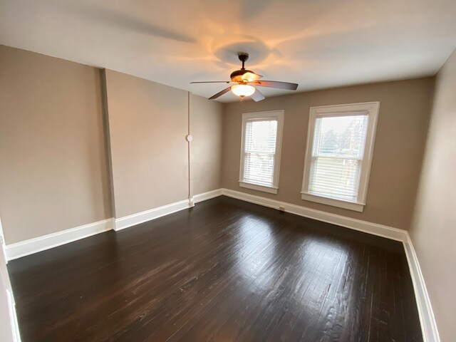 unfurnished room featuring ceiling fan and dark hardwood / wood-style floors