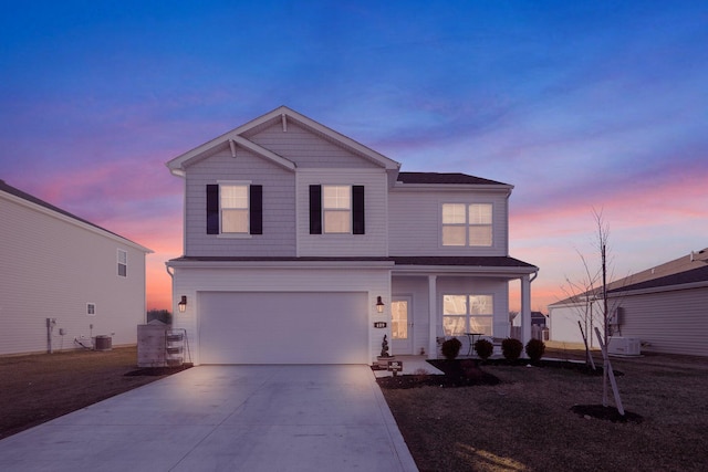 view of front property featuring a garage and central air condition unit