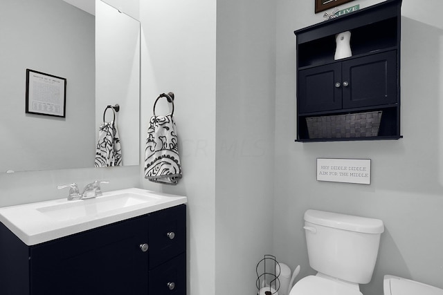 bathroom featuring vanity and toilet