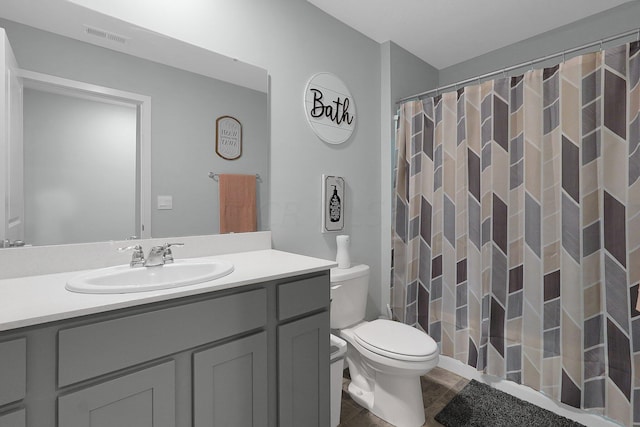 bathroom with tile patterned floors, vanity, toilet, and a shower with curtain