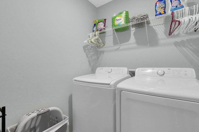 clothes washing area with washer and clothes dryer