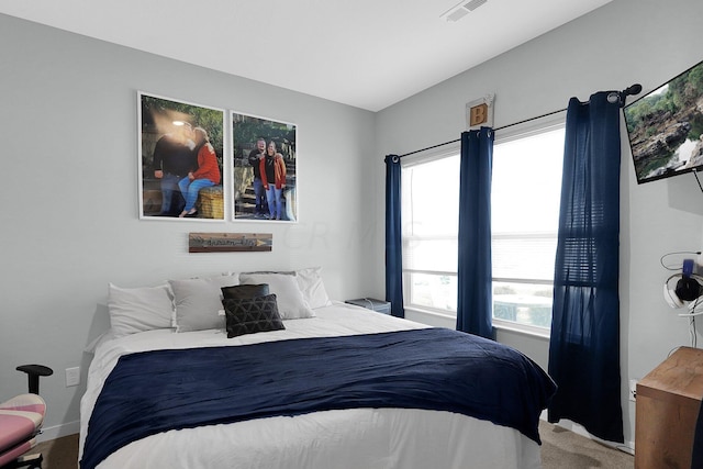 carpeted bedroom featuring multiple windows