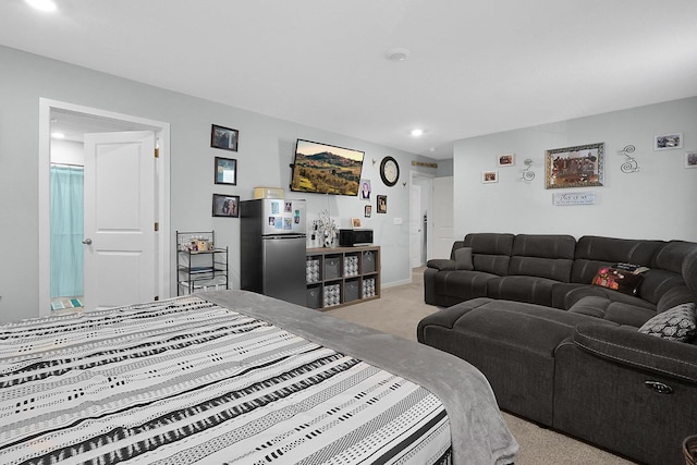 bedroom featuring carpet floors and stainless steel refrigerator