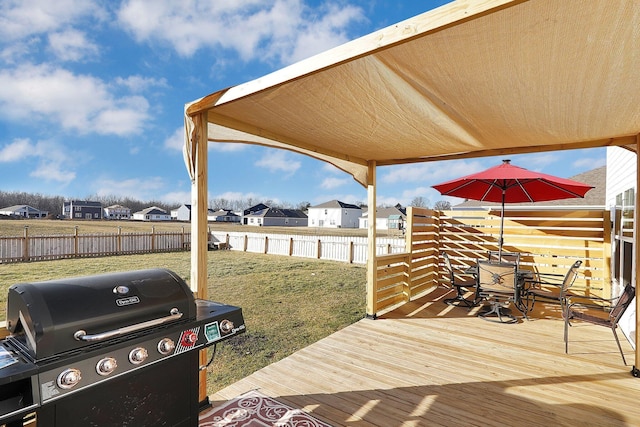 wooden deck with area for grilling and a yard