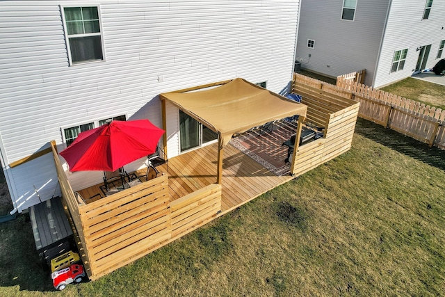 wooden terrace featuring a lawn