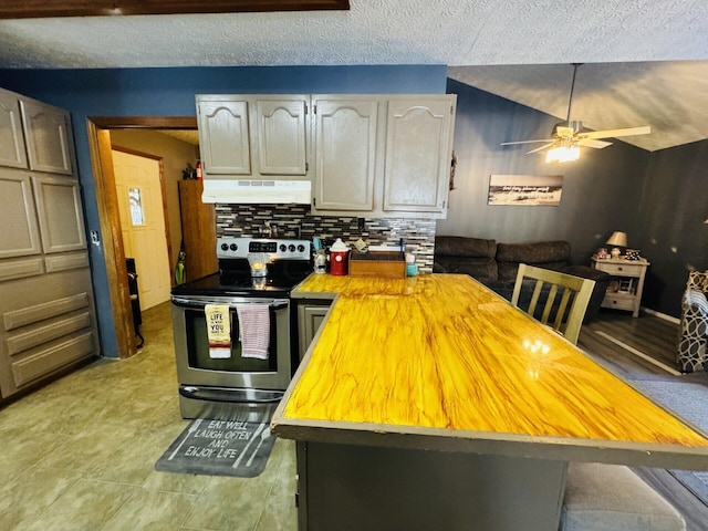 kitchen featuring tasteful backsplash, gray cabinets, stainless steel range with electric stovetop, and lofted ceiling