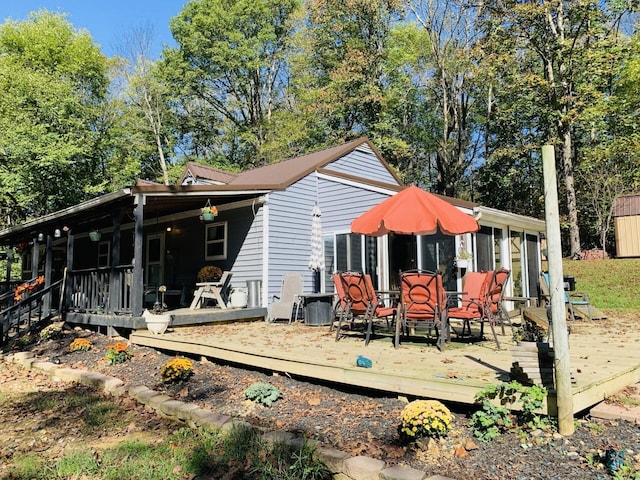 back of house with a wooden deck